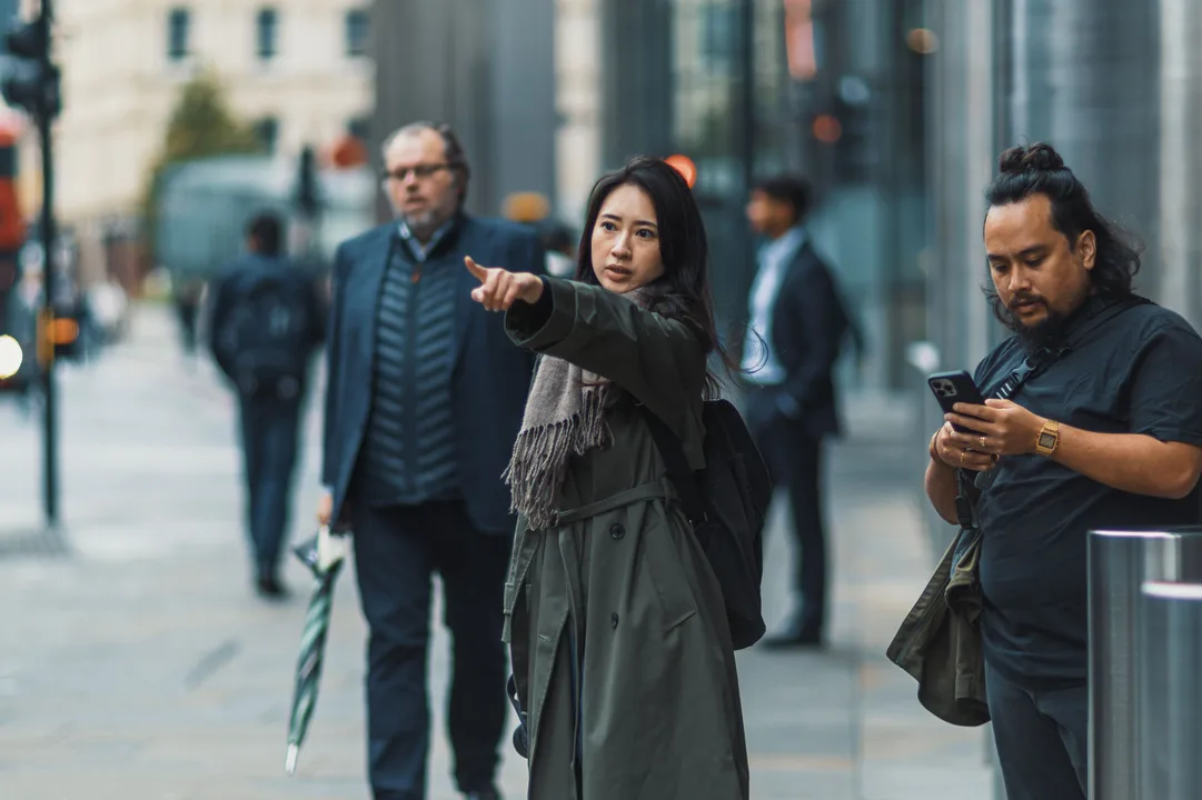 Traveler checking walking directions on a phone on a city street abroad