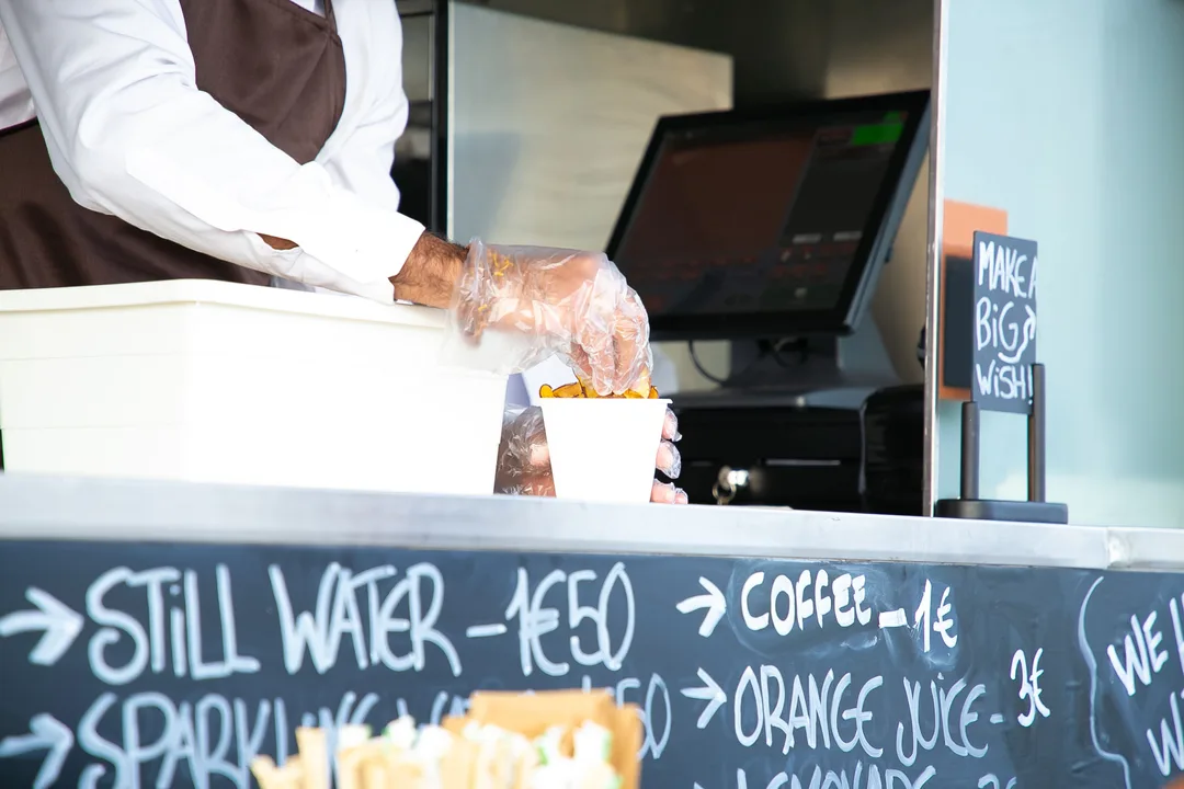 Cashier preparing a takeout food order at a counter