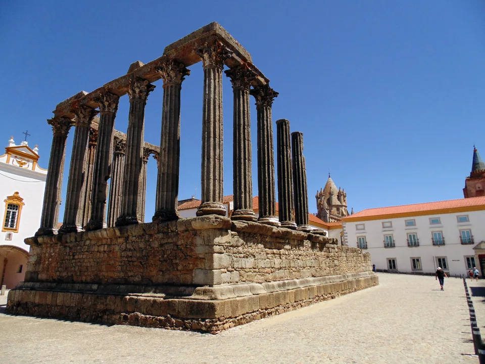 Roman Temple of Évora with tall granite columns against blue sky