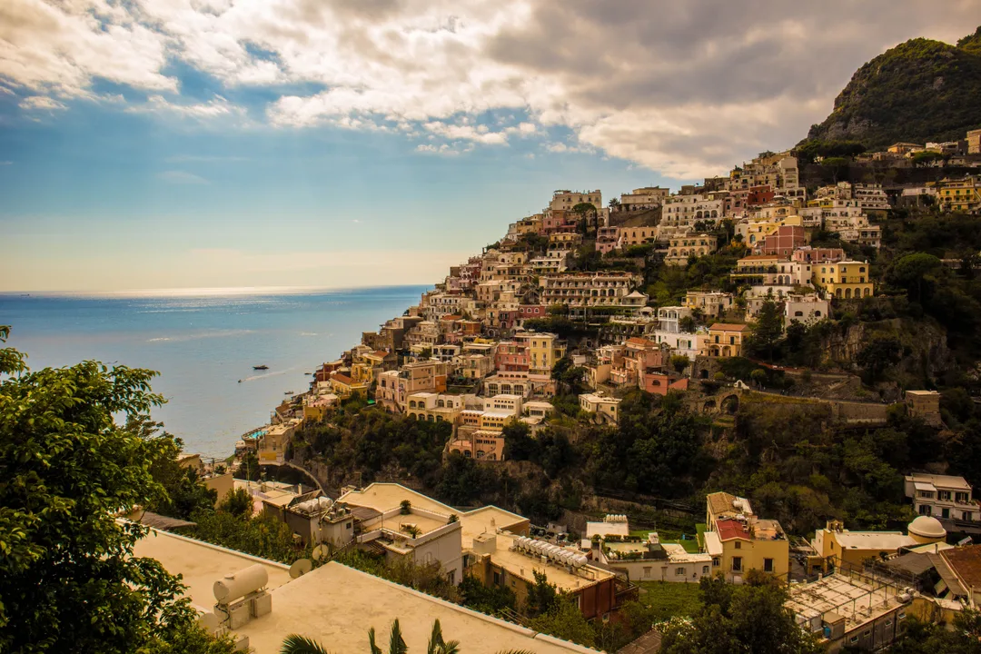 Pastel houses stacked on the cliff above the sea in Positano on the Amalfi Coast