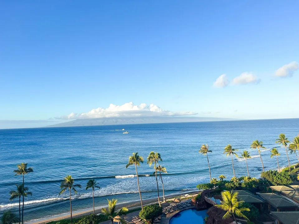 Palm-lined beach on Maui with the island of Lanai across the channel