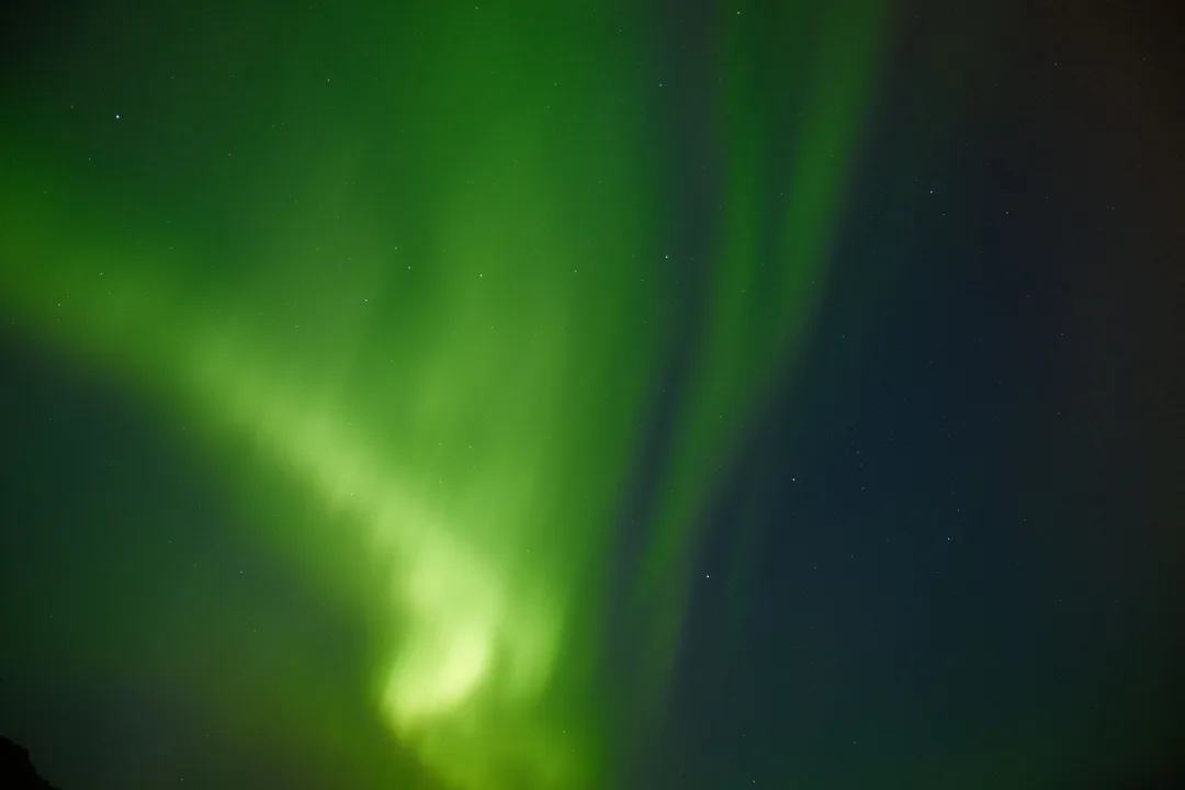 Northern lights aurora borealis streaking across a dark Icelandic sky
