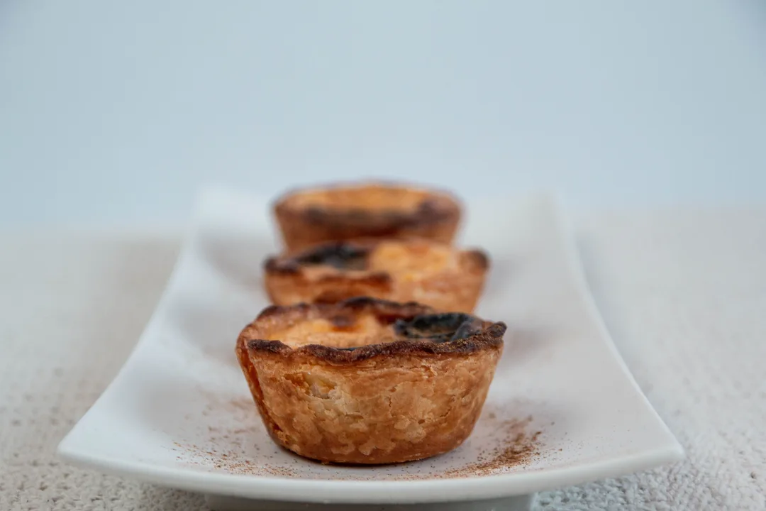 Pastéis de Belém custard tarts dusted with cinnamon in Lisbon